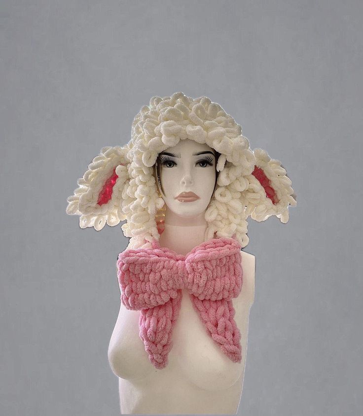 a mannequin head wearing a pink and white knitted hat with large ears