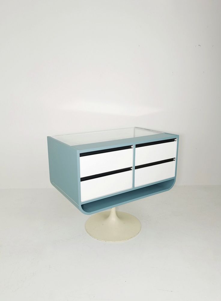 a blue and white cabinet with two drawers on it's side, against a white background