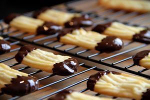 chocolate covered cookies cooling on a rack in a bakery oven, ready to be eaten