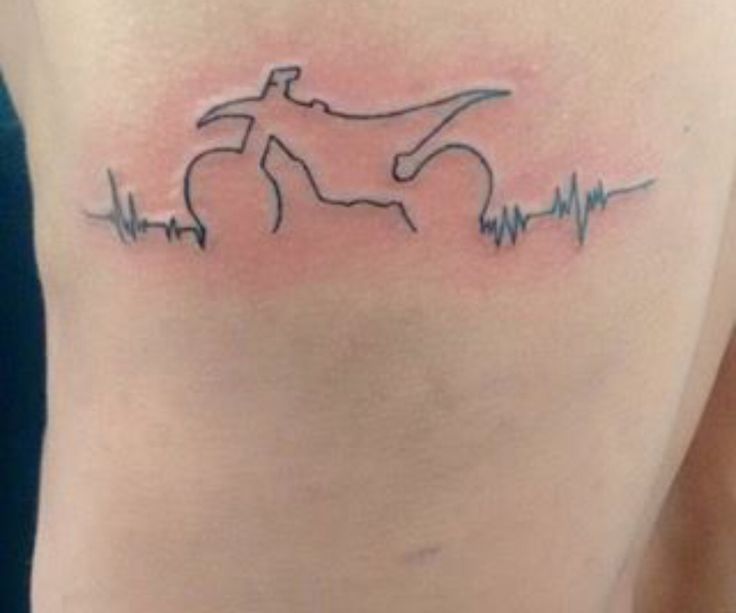 a tattoo on the side of a woman's stomach with a bike and heartbeat