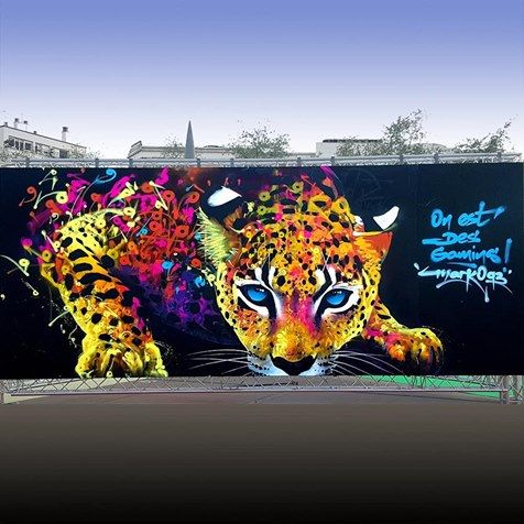 a large mural of a leopard on the side of a building