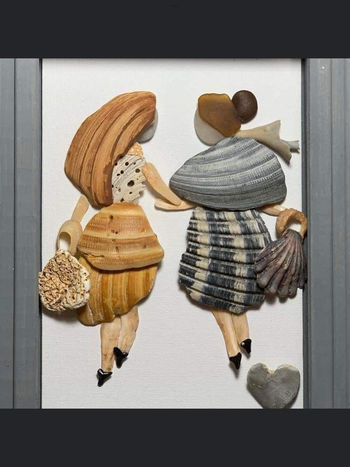 two wooden dolls are standing next to each other with seashells in their hands