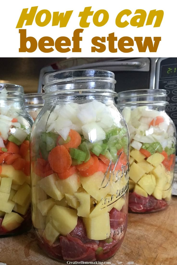 four mason jars filled with food sitting on top of a wooden table