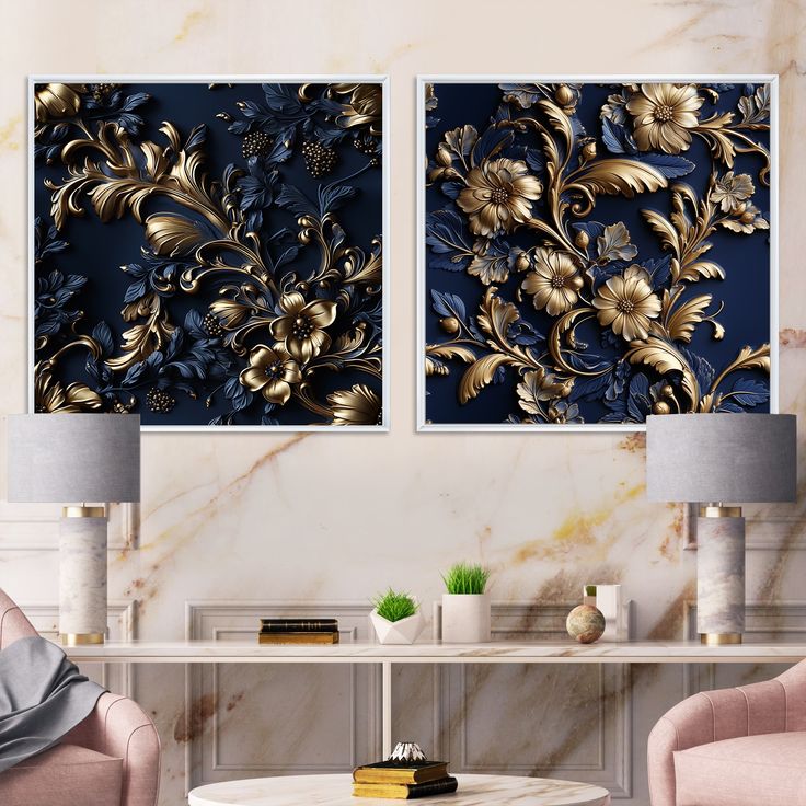 two gold and blue paintings on a wall in a living room with pink chairs, coffee table and lamp