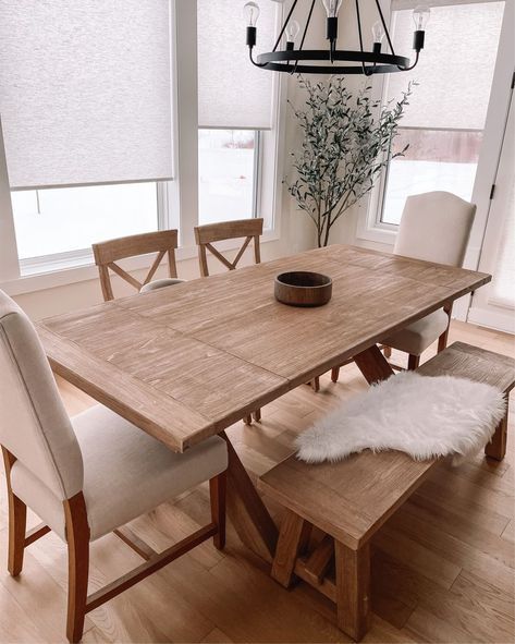 a dining room table with chairs and a bench