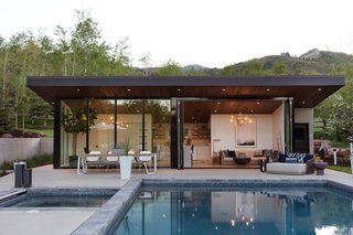 a pool house with an outdoor living area