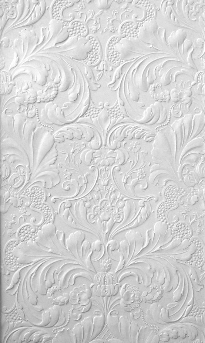 the textured paper is white and has an intricate design on it, as well as flowers