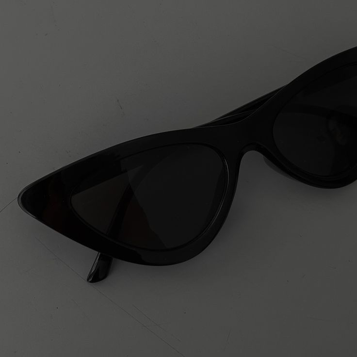 a pair of black sunglasses sitting on top of a table