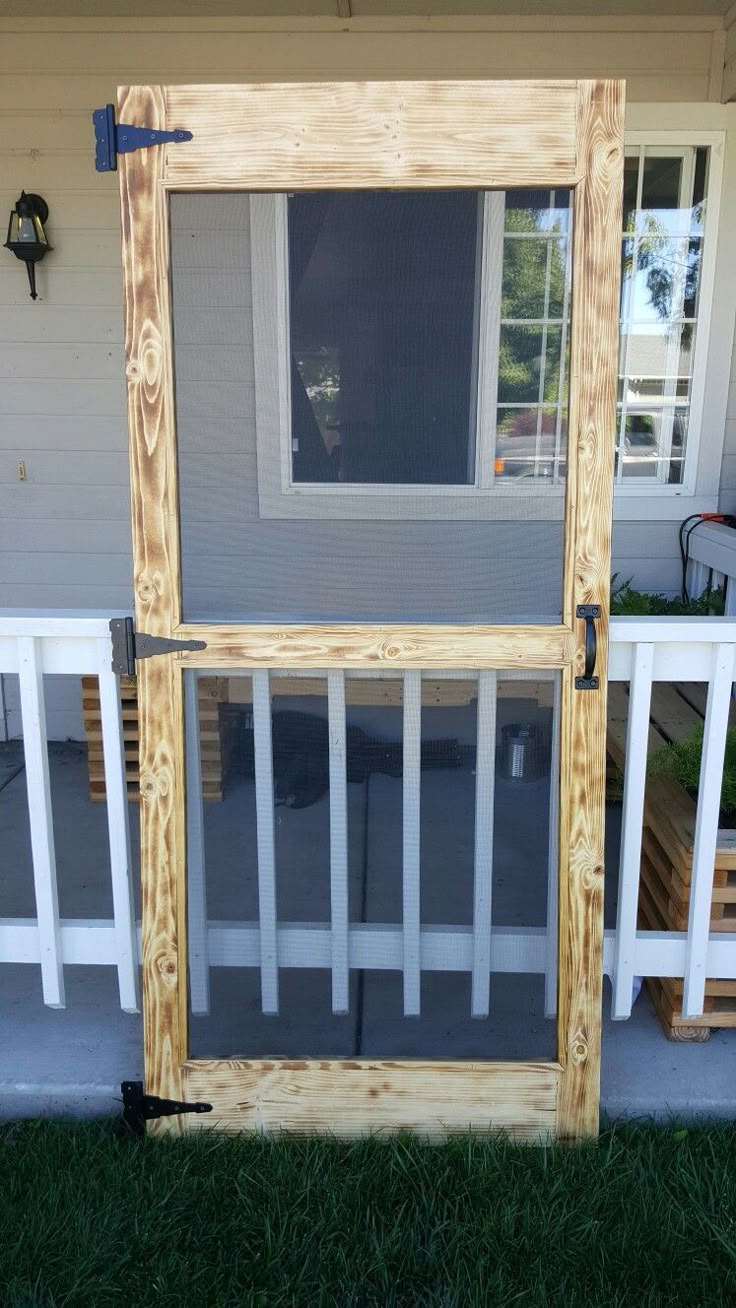 a wooden screen door on the side of a house