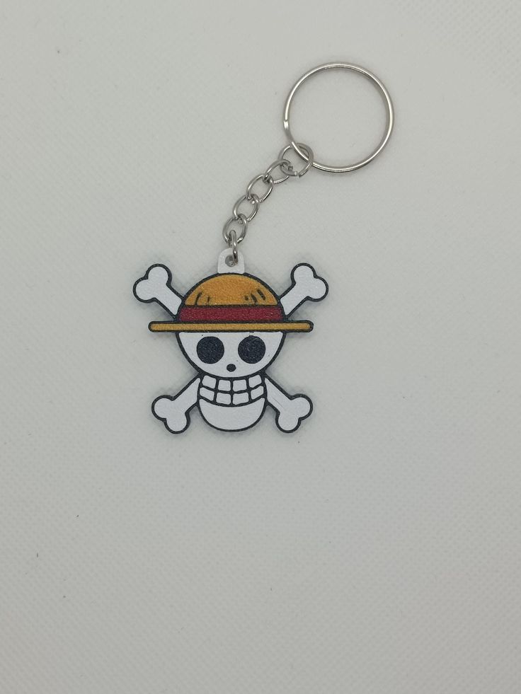 a skull and crossbones keychain with a hat on it's head