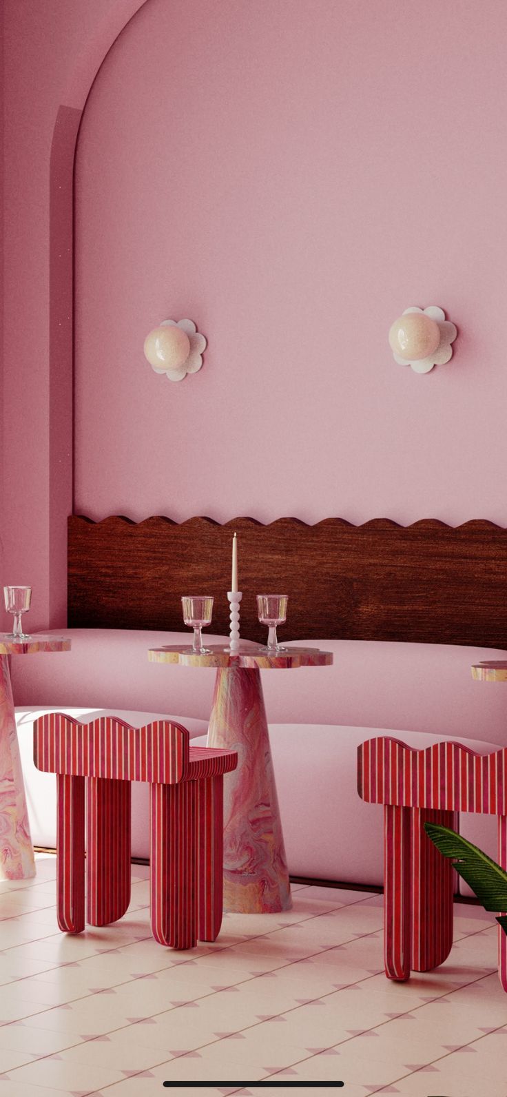 a room with pink walls and tables in the center, surrounded by white tile flooring