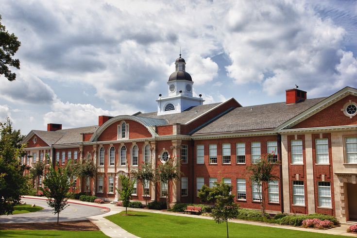 an old brick building with a steeple on top