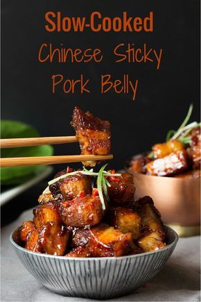 the cover of slow - cooked chinese sticky pork belly with chopsticks sticking out