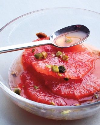 a bowl filled with fruit and sauce on top of a table