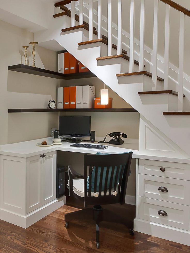 a home office under the stairs with desk and chair