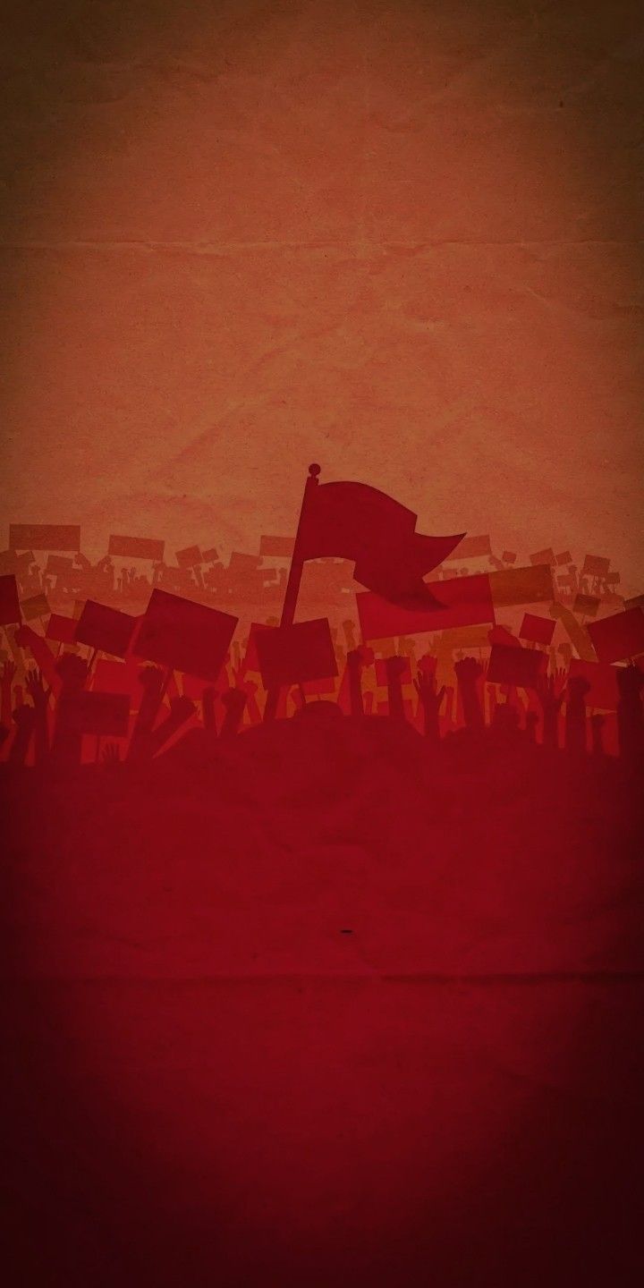 the silhouette of a red flag in front of an orange sky