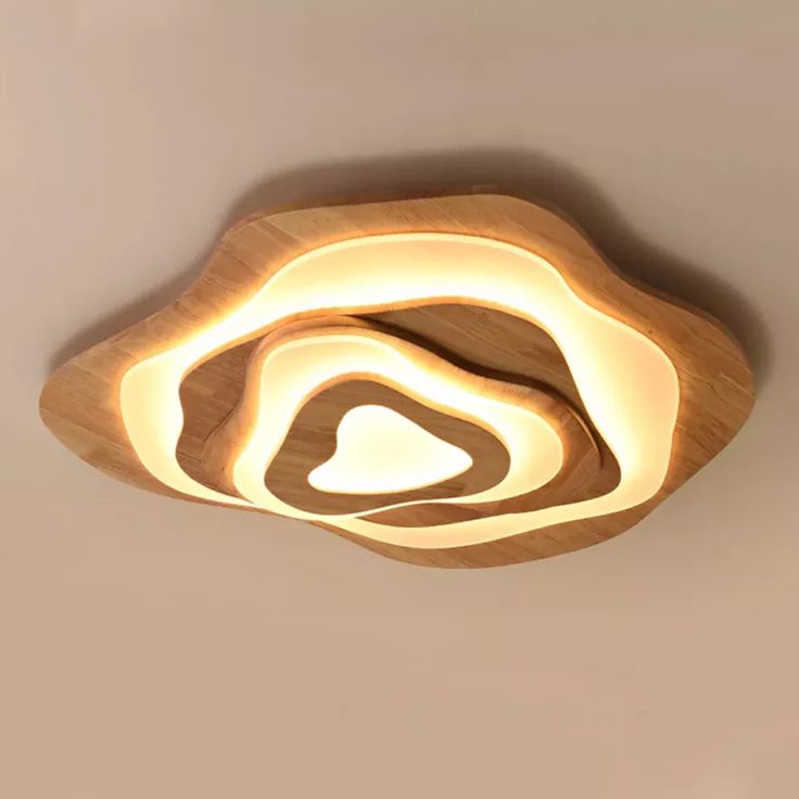 the light fixture is made out of wood and has a circular shape that looks like a spiral