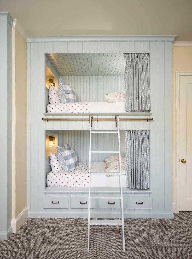 a bunk bed with two sets of drawers and a ladder to the top, in a room with beige carpeting