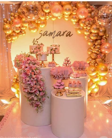 there are many cakes and decorations on the table in front of this backdrop with balloons