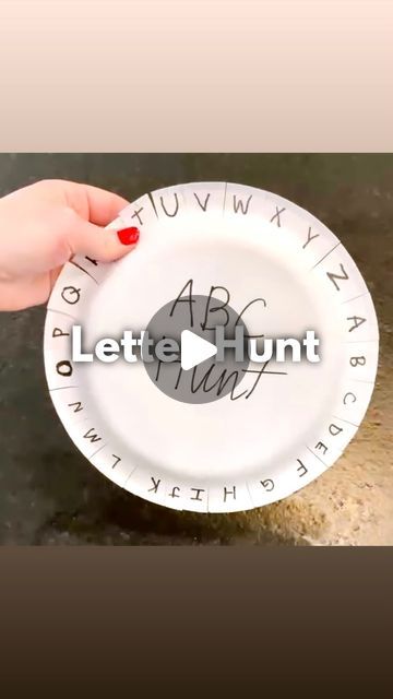 a person holding a white paper plate with writing on it and the words abc, let't be hunt