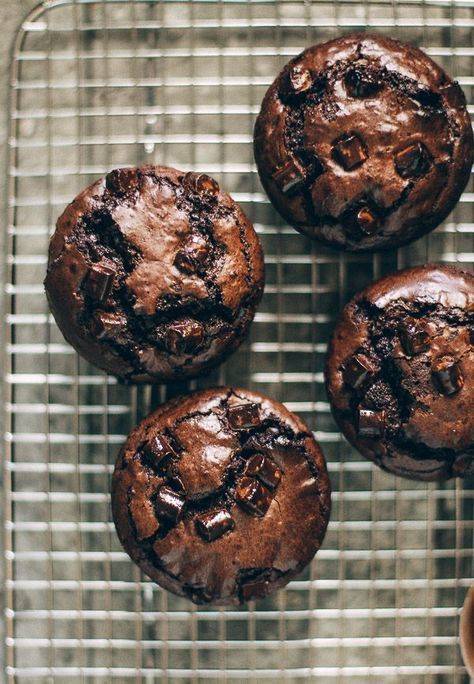 four chocolate muffins on a cooling rack