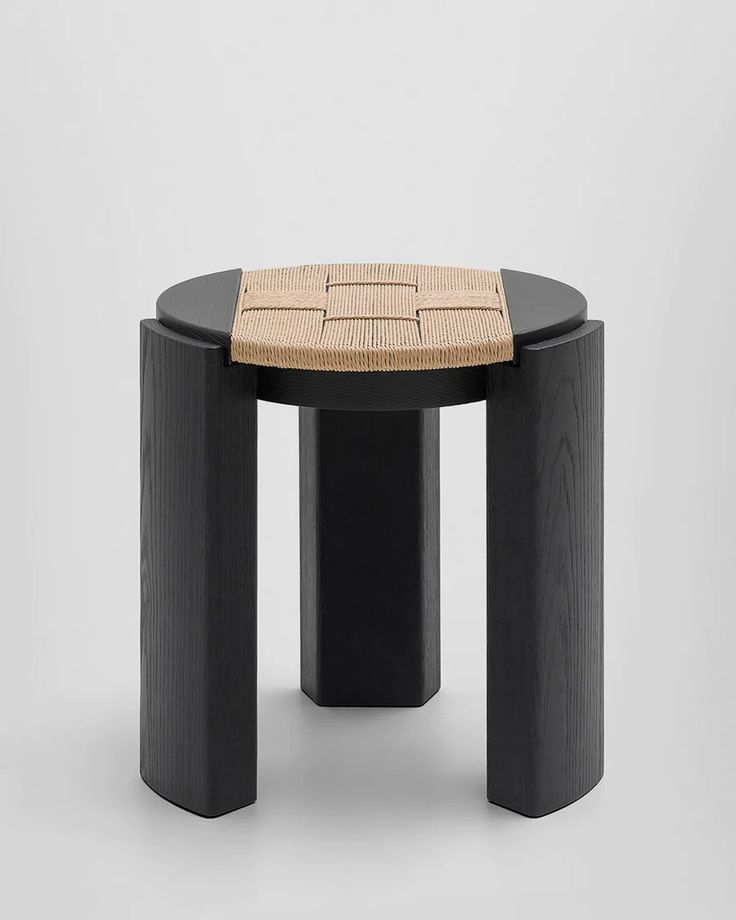 a black table with a woven seat on top