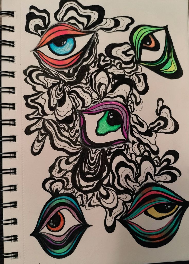 a notebook with an artistic drawing on the front and back cover that has colorful eyes