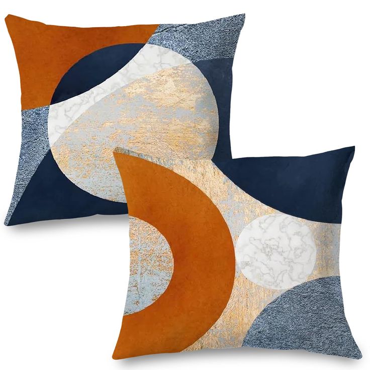 two blue and orange pillows sitting next to each other