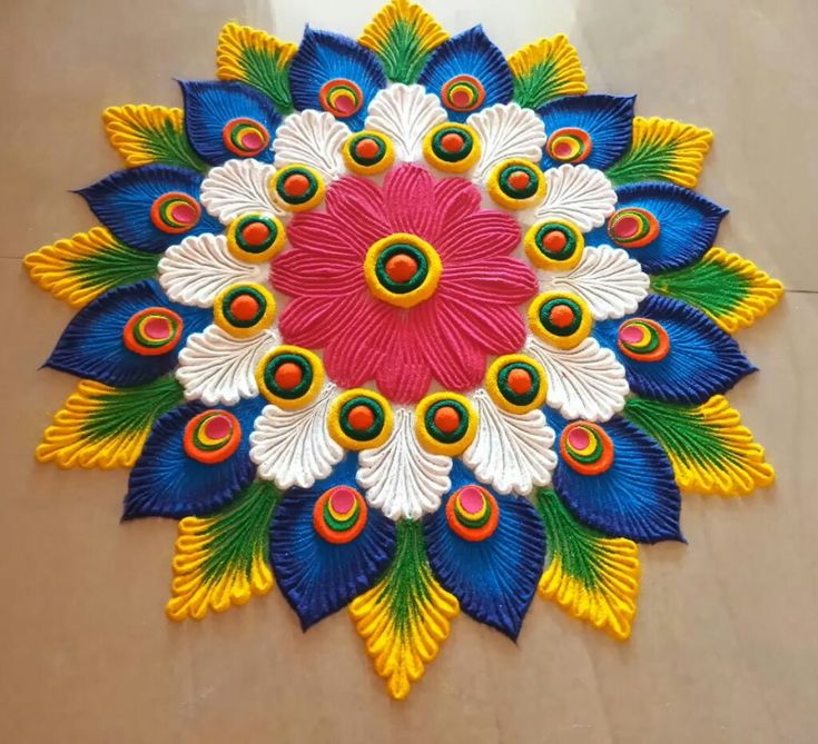 a colorful flower made out of paper sitting on top of a table