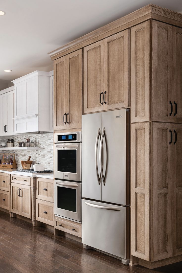 a kitchen with wooden cabinets and stainless steel appliances