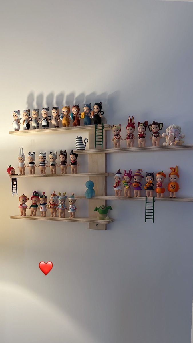 there are several shelves that have many small toys on them and one has a red heart in the middle