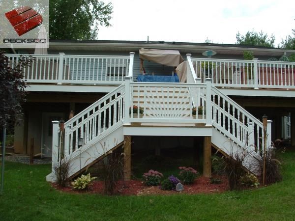 a large white deck in front of a house