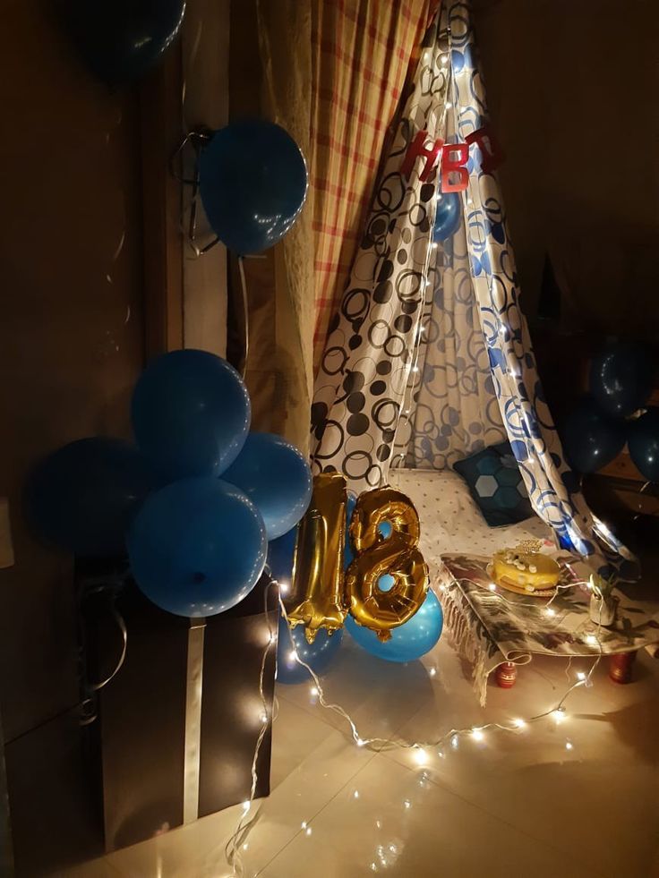 balloons and streamers are on the floor near a teepee tent