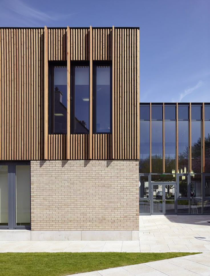 a brick building with glass windows on the side