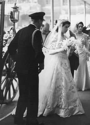 an old black and white photo of a bride walking down the aisle with her father