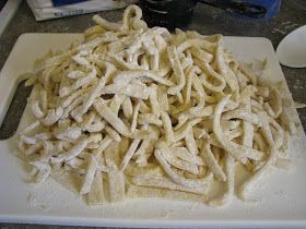 a pile of uncooked pasta sitting on top of a white cutting board