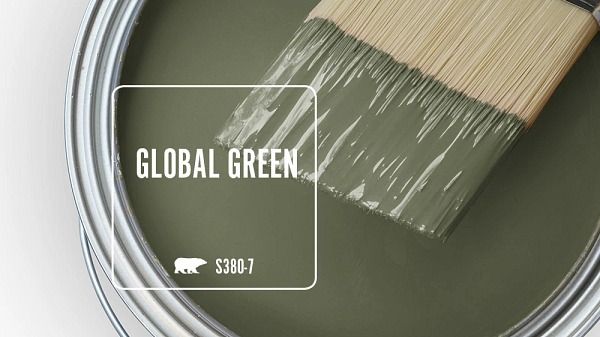 a paint can with a brush in it and the words global green painted on it