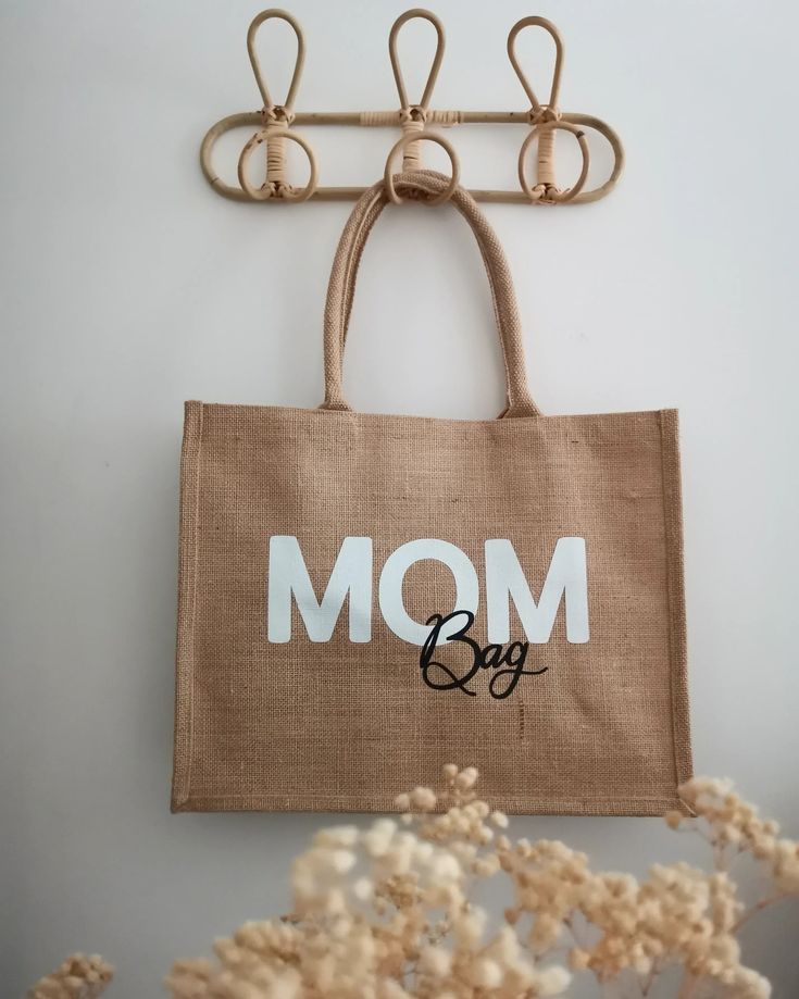 a brown bag with the word mom on it hanging from a hook