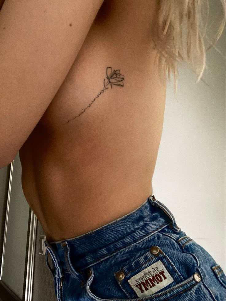 a woman with a small tattoo on her stomach