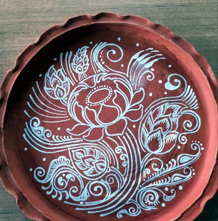 a brown bowl with white designs on it