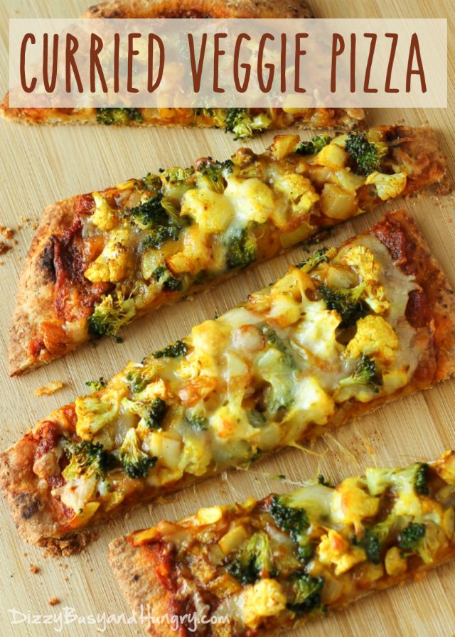 four slices of pizza with cheese and broccoli on them sitting on a cutting board