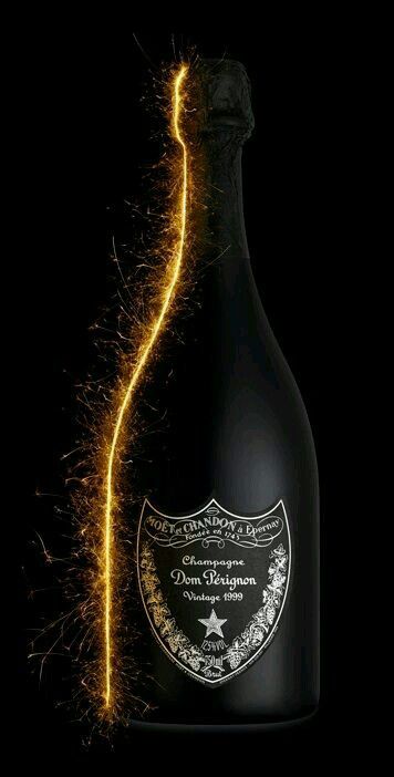 a bottle of champagne is lit up with sparklers