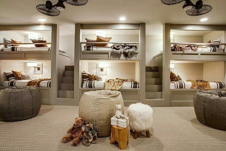 a room filled with bunk beds and stuffed animals