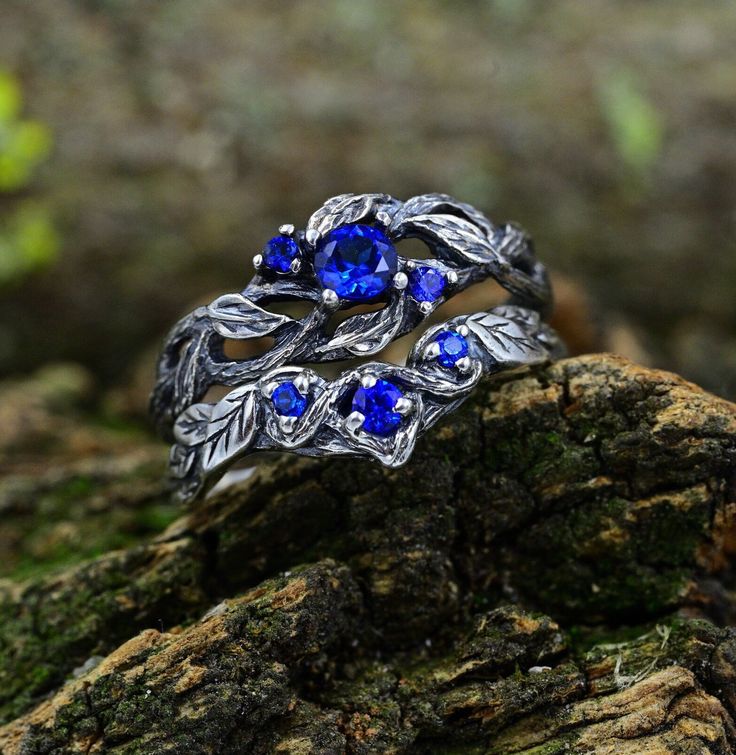 This unique set goes beyond traditional designs, capturing the essence of ethereal fairy tales and elven elegance. Perfect for those seeking a cottagecore vibe, this Nature Wedding Ring Set is a symbol of enduring love, blending the whimsy of fantasy with the timeless beauty of Celtic traditions.  Characteristics: Metal - Recycled solid sterling silver  Stone - Cubic Zirconia Finish - Oxidized. View all silver fantasy rings: https://www.etsy.com/shop/TinyShinyJewel?ref=seller-platform-mcnav&sect Silver Ethereal Jewelry With Birthstone, Silver Crystal Wedding Ring With Birthstone, Silver Sapphire Crystal Ring For Wedding, Wedding Silver Sapphire Crystal Ring, Nature-inspired Wedding Rings With Prong Setting, Wedding Sapphire Crystal Ring In Silver, Silver Birthstone Crystal Ring For Wedding, Silver Nature-inspired Crystal Wedding Ring, Silver Nature-inspired Wedding Jewelry