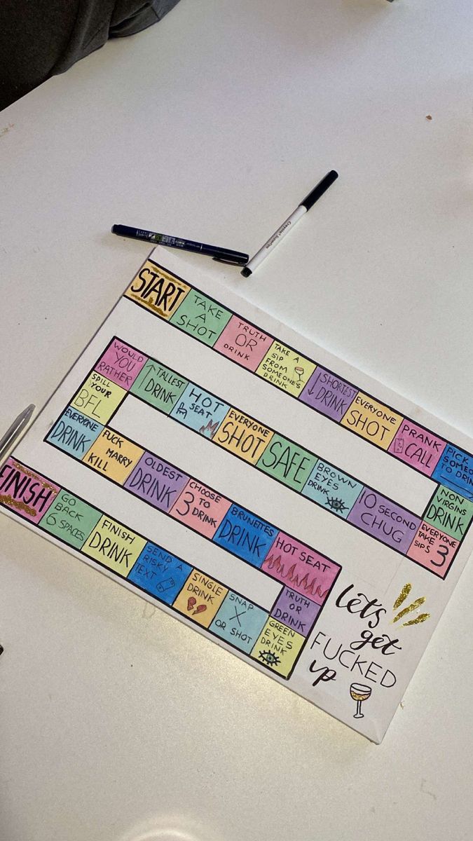 a board game sitting on top of a table next to a marker and some pens