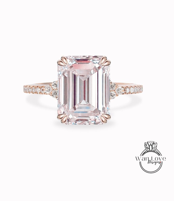 an emerald cut diamond ring with diamonds around it