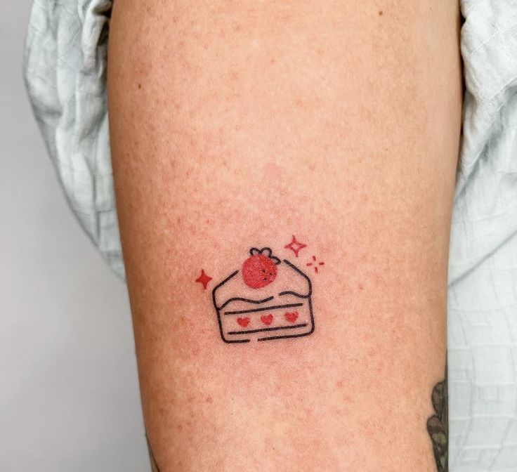 a small piece of cake tattoo on the arm