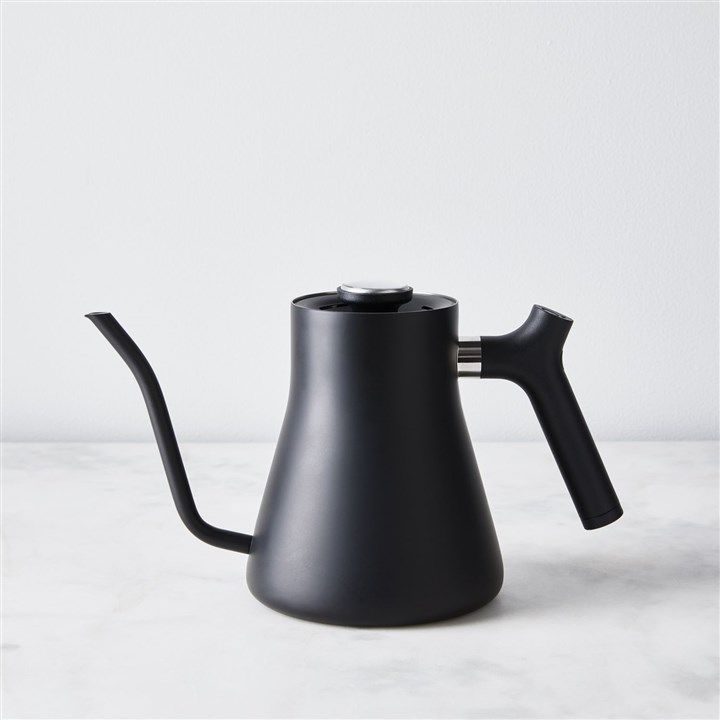 a black coffee pot with a handle on a marble surface