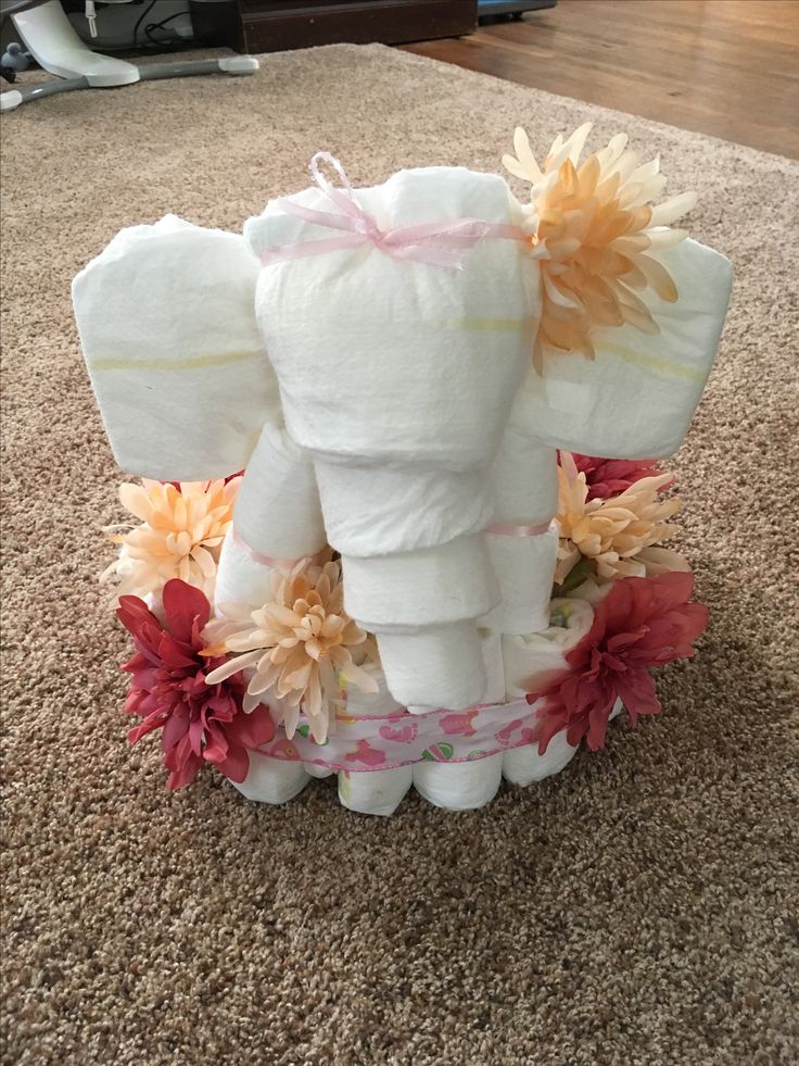 an elephant made out of toilet paper with flowers on it's trunk and tusks