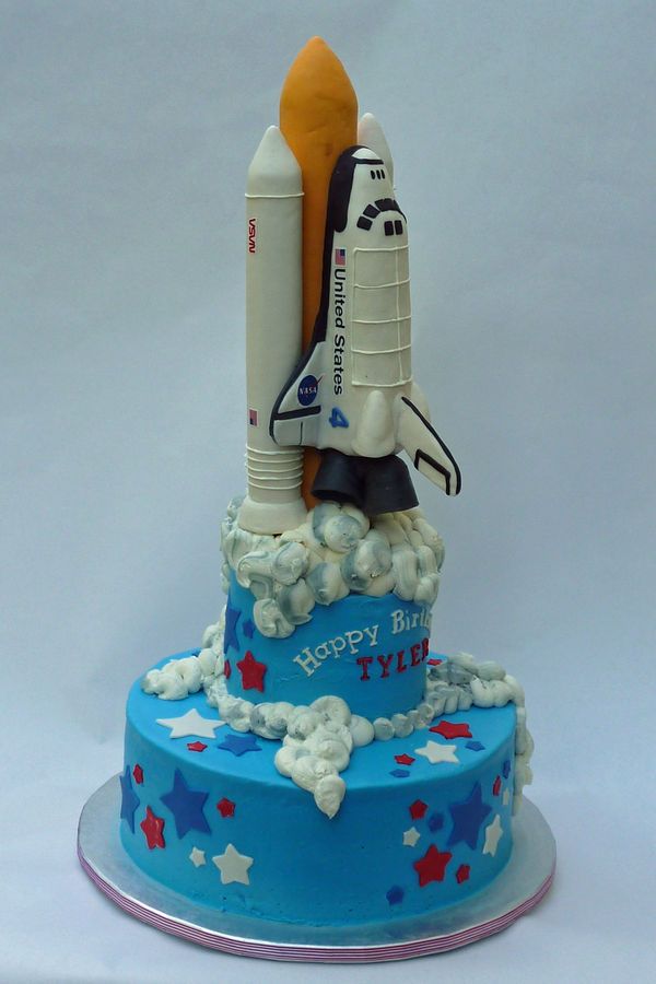 a birthday cake made to look like a rocket ship